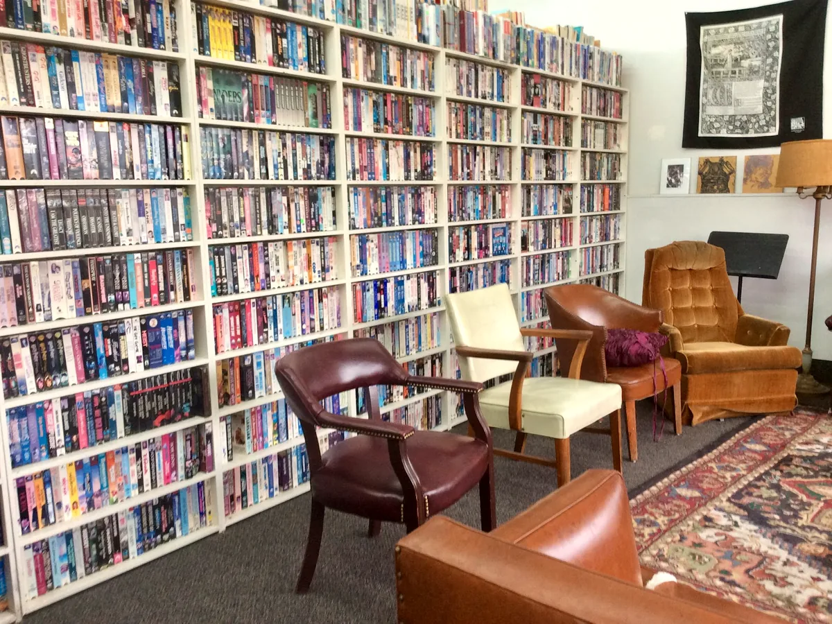 Reading chairs and packed shelves at the Oak Cliff store